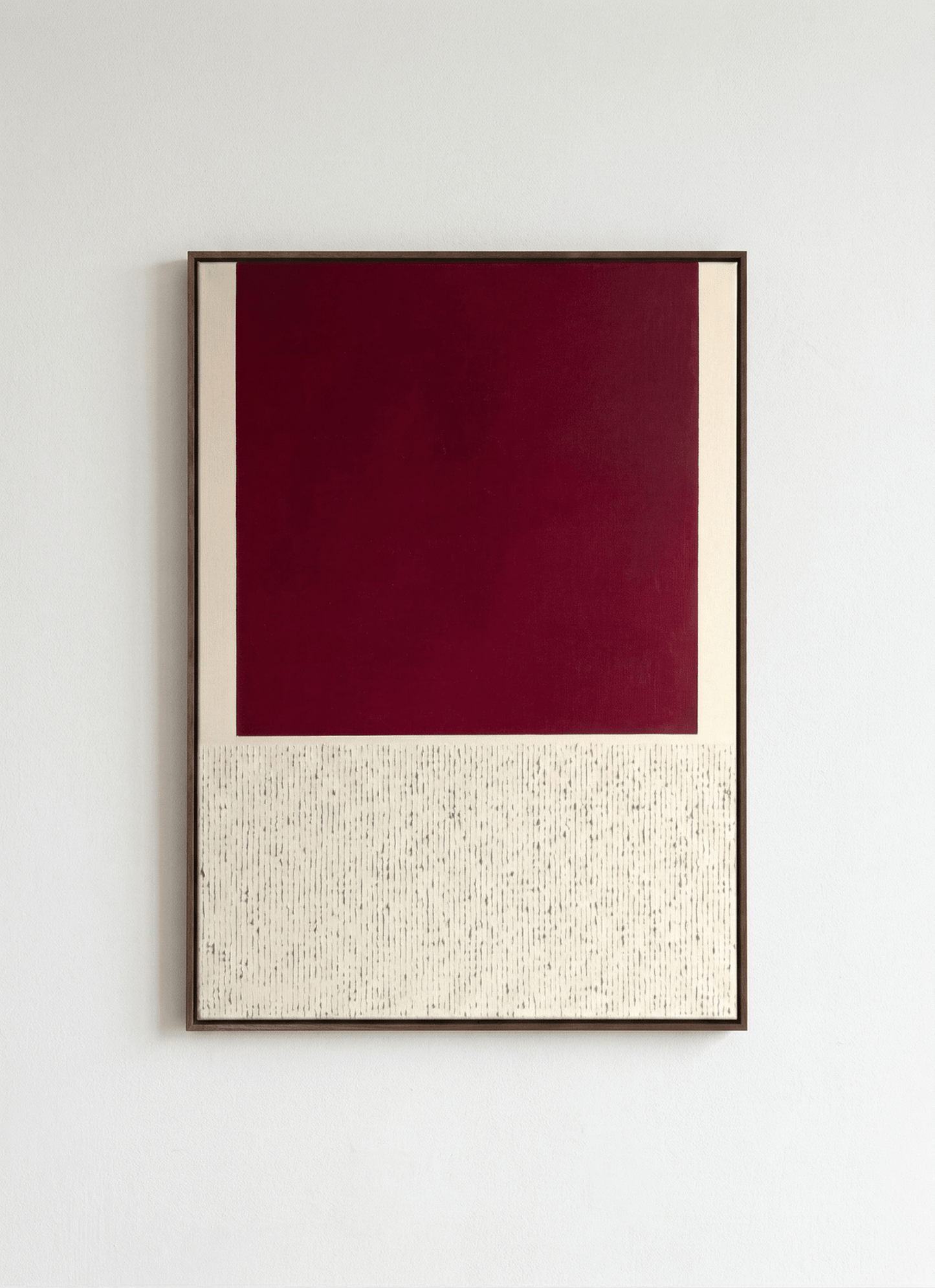 Framed artwork with a red and beige design on a white wall