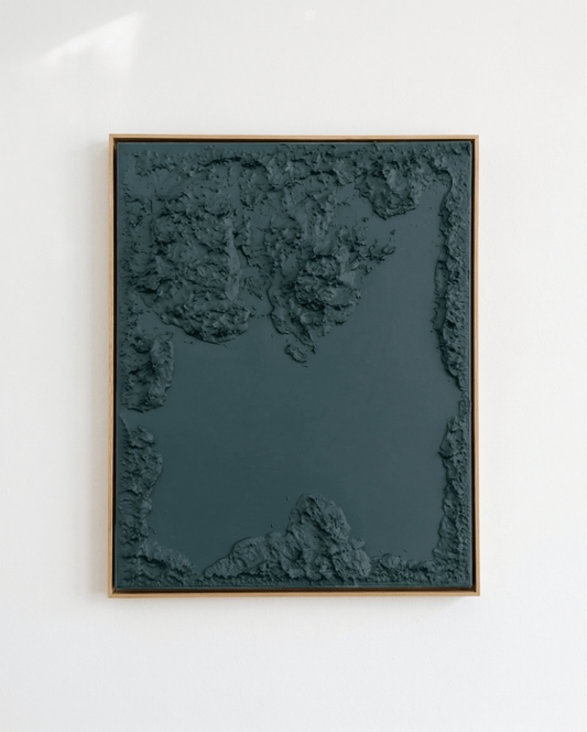 Framed abstract art piece on a white wall