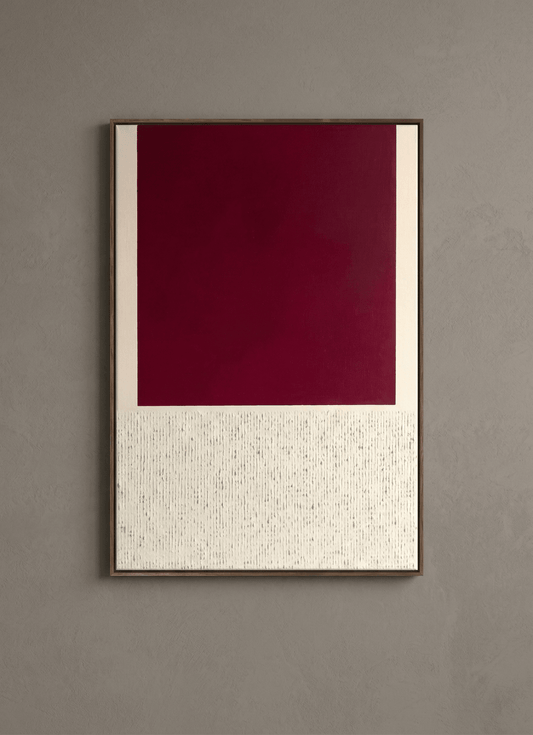 Framed artwork with a red square and white patterned border on a gray wall